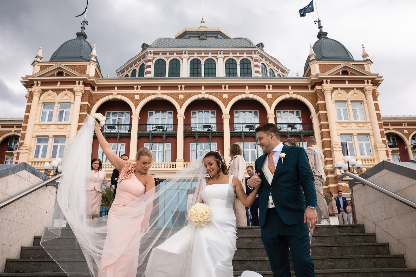 Bruidspaar op de trap bij Kuhrhaus in Scheveningen trouwfotograaf Den Haag